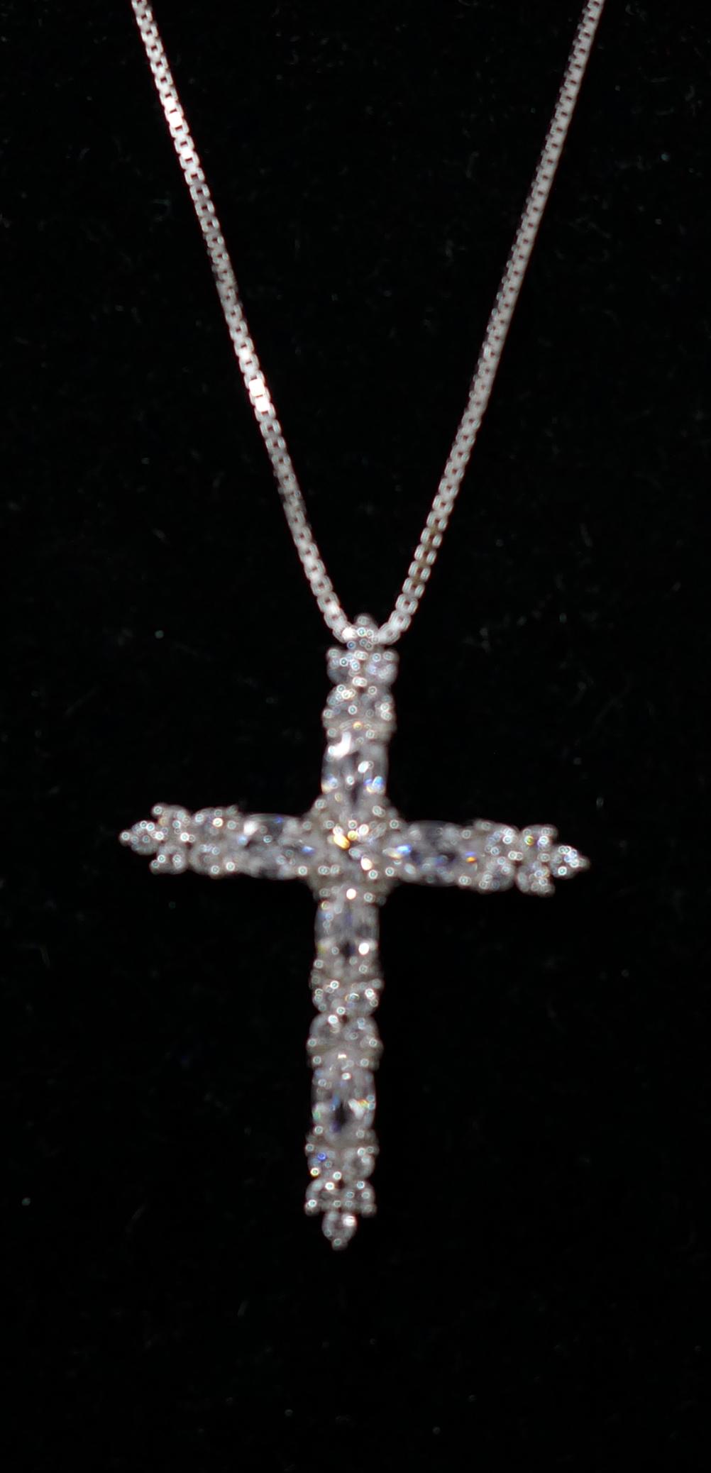 A sterling silver and white crystal studded crucifix pendant on a sterling silver chain