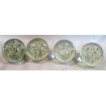 A set of four large glass paperweights/door stops