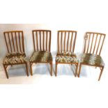 A set of four 20th century teak dining chairs