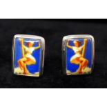 A pair of sterling silver cufflinks each set with a ceramic rectangular panel depicting a pin-up