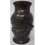 A Chinese bronze baluster vase, decorated with birds hunting among trees, bearing impressed seal