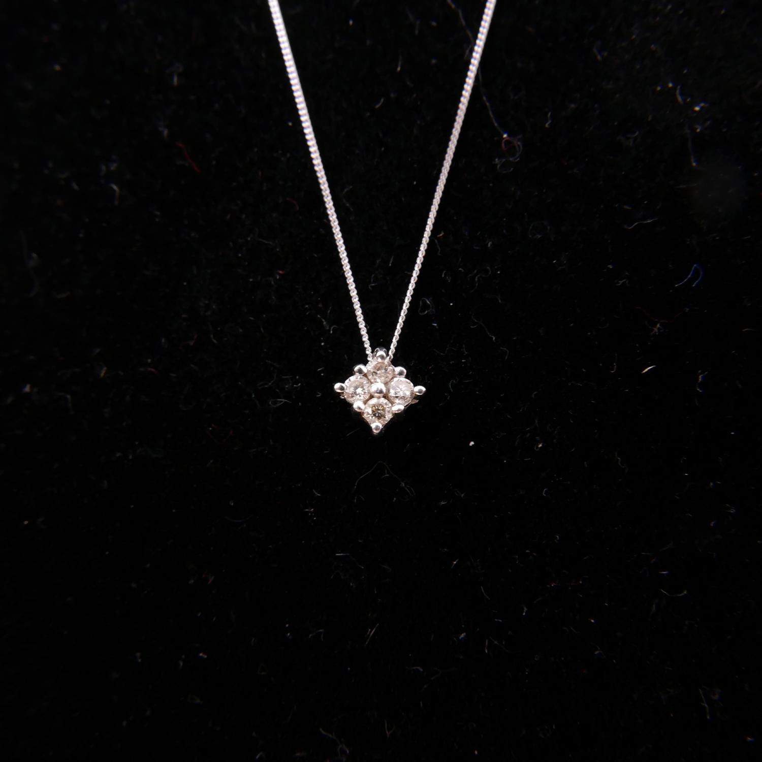 A 10ct white gold and diamond pendant set with 4 stones on white gold chain, in box, 1 gram