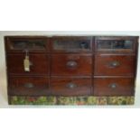 A late 19th/early 20th century mahogany and decoupage shop's haberdashery chest, with three glass