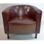 A brown leather tub chair raised on steel legs