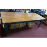 A French elm top farmhouse dining table, with two drawers, raised on green painted base, H.78 W.