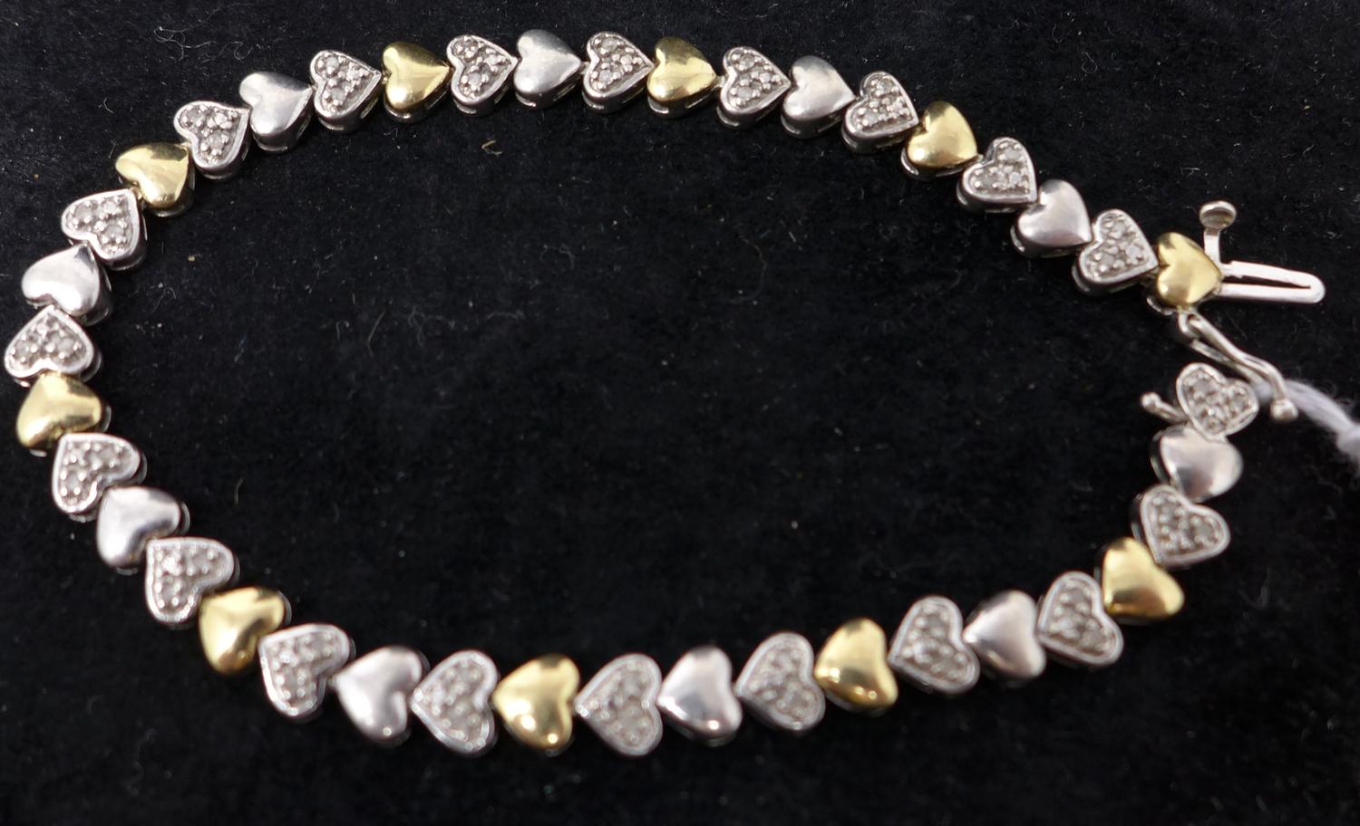 A gold and silver bracelet set with diamonds