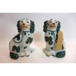 A pair of late 19th century ceramic Staffordshire dogs with green, white and gold detailing,