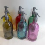 A set of six multi coloured soda syphons