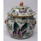 A 20th century Chinese pot an cover, painted with butterflies, flowers and pomegranates, bearing six