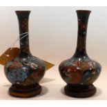 A pair of early 20th century Japanese cloisonne vases, on circular hardwood stand bases, H.14cm