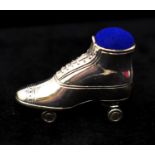 A sterling silver pin cushion in the form of a roller skate with blue velvet padded top