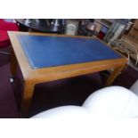 A 1930's light oak library table, with leather inset top, raised on tapered legs and spade feet, H.