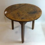 An early 19th century elm cricket table, H.57 Diameter 67cm