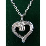 A boxed 14ct white gold diamond studded heart-shaped pendant on white gold chain