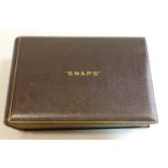 A large brown leather-bound photo album embossed in gilt letters to the top 'Snaps', circa 1920's,