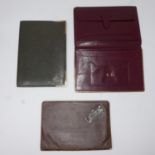 Three leather wallets to include a wine-red and gilt metal Cartier example, 16.5 x 11cm, Stamped '
