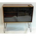 A Danish rosewood side cabinet, with smoked glass sliding doors, raised on hairpin legs, H.86 W.86