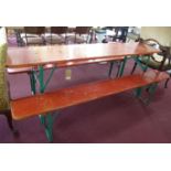 A Hans Bauman red painted table and two benches, with folding legs, monogrammed HB