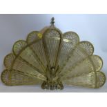 An early 20th century pierced brass peacock firescreen, H.64 W.94cm (fully extended)