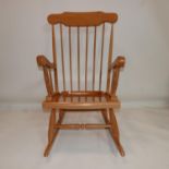 A 20th century beech wood rocking chair