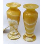 A pair of Egyptian alabaster vases, on circular bases, H.24cm (2)