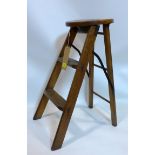 A 20th century oak ladder/stool with makers plaque for Banfield knight & co