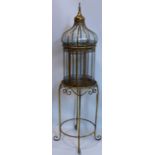 A contemporary gilt storm lantern, on a circular stand raised on scroll feet, H.73cm (lantern), H.