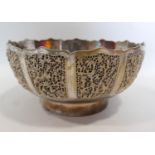 An Indian white metal bowl, with pierced vignettes of birds on scrolling foliage, having floral