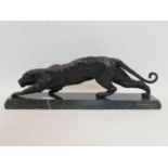 A cast bronze jaguar, raised on stepped rectangular marble base, H.23 W.66 D.15cm