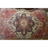 A North West Persian Heriz carpet, central diamond medallion with repeating petal motifs on a