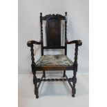 An Art Nouveau oak armchair with barley twist supports
