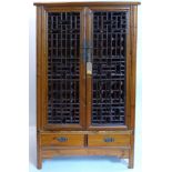 A 20th century Chinese wedding/wine cabinet, two doors enclosing pull out wine rack above two