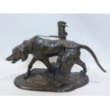 A cast bronze figure of a dog tied to a tree stump, on naturalistic base, H.45 W.60 D.29cm