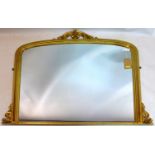 A contemporary gilt wood overmantle mirror, with pierced floral finial, 112 x 125cm