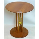 A contemporary circular cherry wood lamp table, raised on four cylindrical supports, H.51 D.45cm