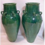 A pair of Persian green glazed Sharab wine vessels, H.92cm (2)