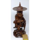 A 19th century Chinese carved walnut figure with ivory teeth, H.43cm