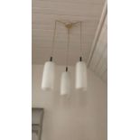 A pair of vintage triple ceiling light pendants, by Marlin, with glass shades.