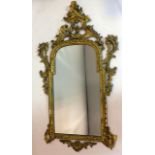 A 19th century carved gilt wood mirror, with later bevelled plate, restored, some pieces detached,