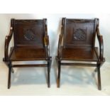 A pair of 19th century oak Glastonbury chairs with carved panels