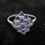 A boxed 9ct white gold marquise-shaped ring set with diamonds and tanzantites, Size: W 1/2, 3g.