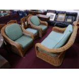 A rattan suite of furniture comprising of a sofa, pair of chairs and stool