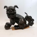 Late 18th / early 19th century Chinese solid bronze Dog of Fo, H.15 W.19 D.9cm, on ebonised