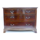 An Edwardian mahogany chest of two short over three long drawers, raised on bracket feet, H.79 W.107