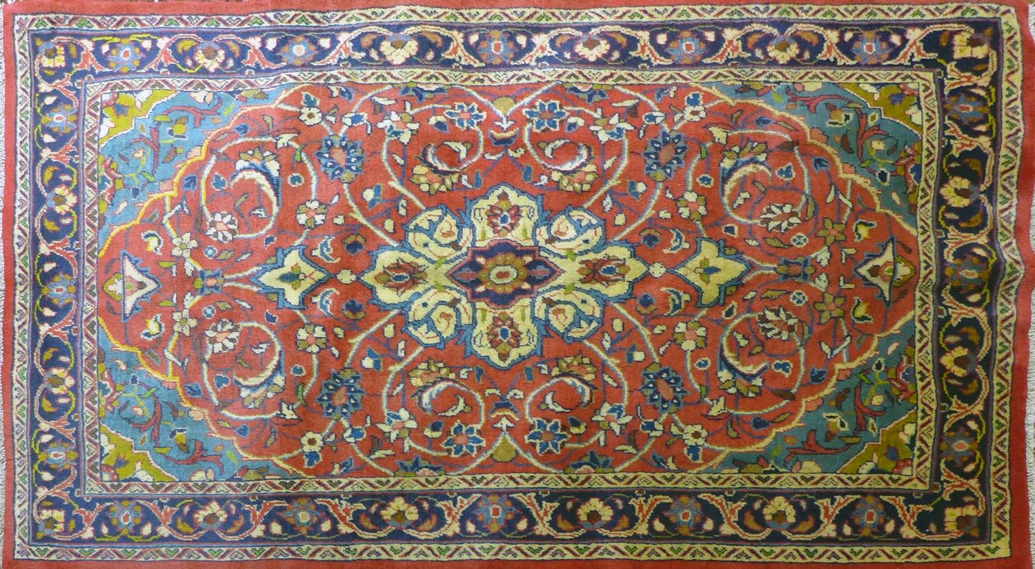 A North West Persian Mahal rug, double pendent medallion with repeating spandrels on a rouge