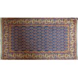 A Persian rug with geometric design on a blue and red ground, 152 x 78cm