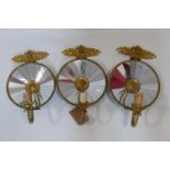 A set of three Empire style gilt metal wall lights with mirrored backs, H.45 W.26cm