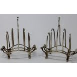A pair of early 20th century silver toast racks, raised on scrolling feet, by William Comyns &