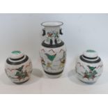 A late 19th/early 20th century Chinese crackle glazed vase and matching pair of ginger jars,