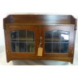 An Arts and Crafts oak wall hanging cabinet, H.71 W.91 D.25cm